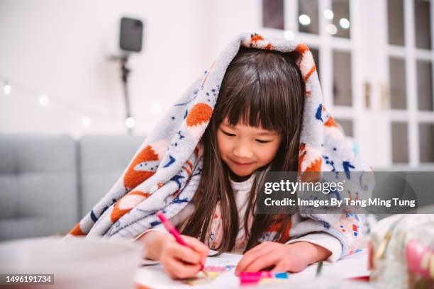 lovely cheerful girl in pajama drawing picture under a blanket at home - draw stock pictures, royalty-free photos & images