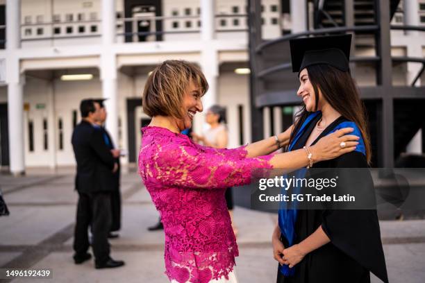 young graduate woman talking with her mother on the graduation - mother congratulating stock pictures, royalty-free photos & images