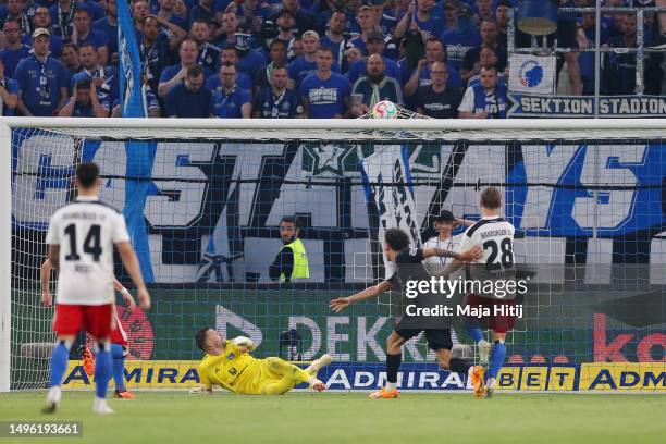 Daniel Heuer Fernandes of Hamburger SV fails to stop a goal scored by Enzo Millot of VfB Stuttgart, his team's first goal during the Bundesliga...