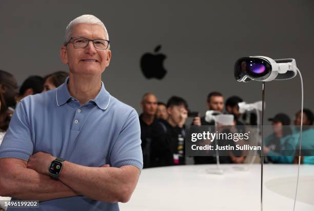 Apple CEO Tim Cook stands next to the new Apple Vision Pro headset is displayed during the Apple Worldwide Developers Conference on June 05, 2023 in...