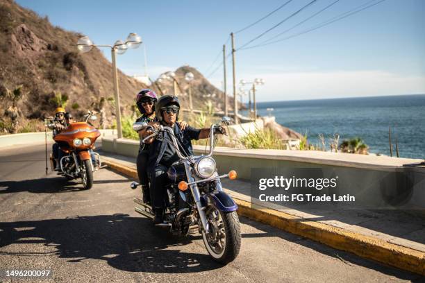 mature couples having a road trip on a motorbike - protective sportswear stock pictures, royalty-free photos & images