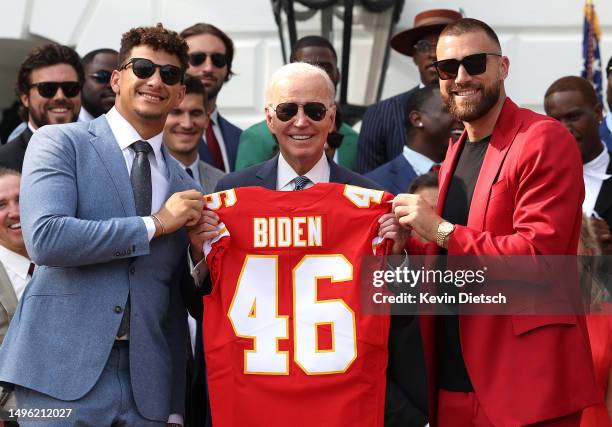 Quarterback Patrick Mahomes and tight end Travis Kelce of the NFL Kansas City Chiefs present U.S. President Joe Biden a team jersey at the White...