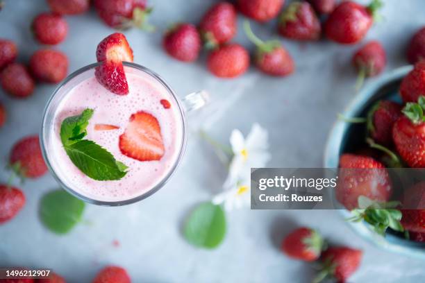 strawberry cocktail with strawberries on kitchen counter - milkshake stock pictures, royalty-free photos & images