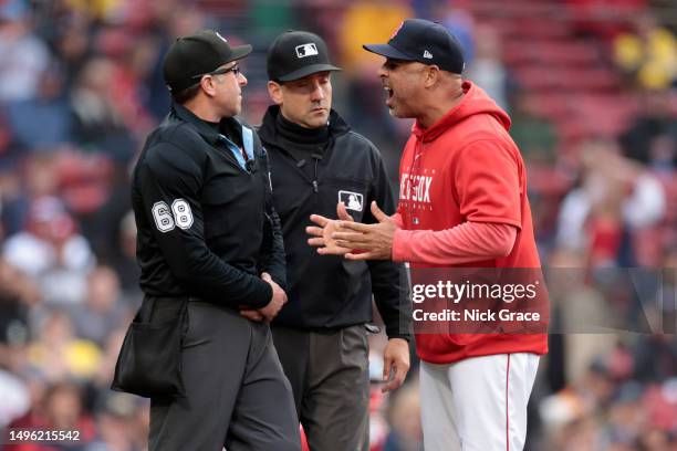 Manager Alex Cora of the Boston Red Sox argues with home plate umpire Chris Guccione during the eighth inning against the Tampa Bay Rays at Fenway...