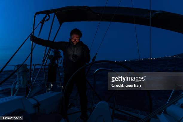 captain sailing by yacht at night. - boat gps stockfoto's en -beelden