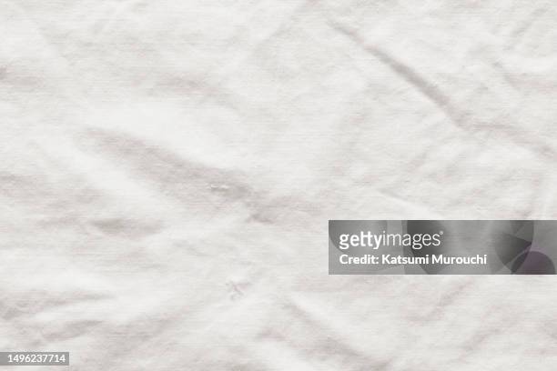 wrinkled white linen fabric textured background - tischtuch stock-fotos und bilder