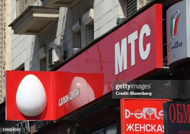 The logo of OAO Mobile TeleSystems sits on display outside one of the company's stores in Moscow, Russia, on Wednesday, Aug. 1, 2012. OAO Mobile...