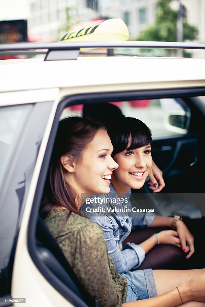 Two young women in taxi