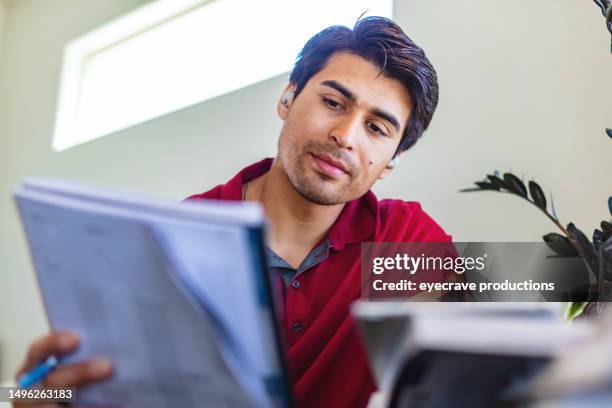 hispanic adult male army veteran working from home in western usa photo series - mexican american stock pictures, royalty-free photos & images
