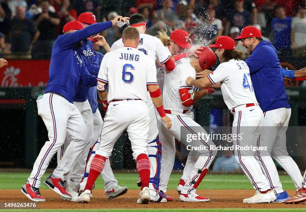 The Texas Rangers including Josh Jung and Josh Smith celebrate the game winning run in the ninth inning against the St. Louis Cardinals at Globe Life...