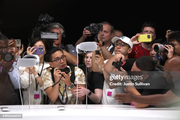 Members of the media inspect the new Apple Vision Pro headset during the Apple Worldwide Developers Conference on June 05, 2023 in Cupertino,...
