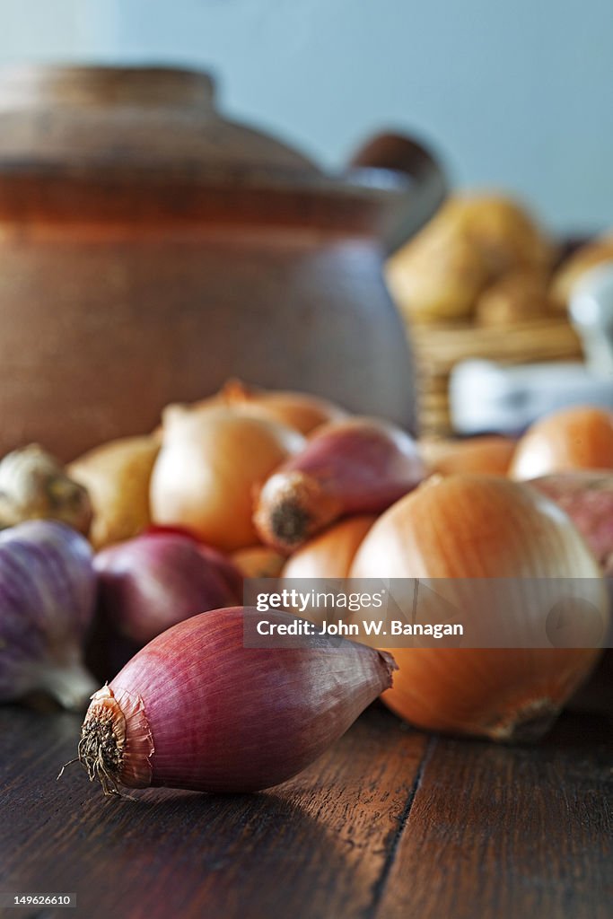 Vegetables and a cooking pot on a  wooden table