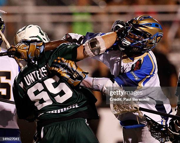 Jovan Miller of the Charlotte Hounds checks Mike Unterstein of the Long Island Lizards in the fourth quarter of a Lacrosse game at James M. Shuart...