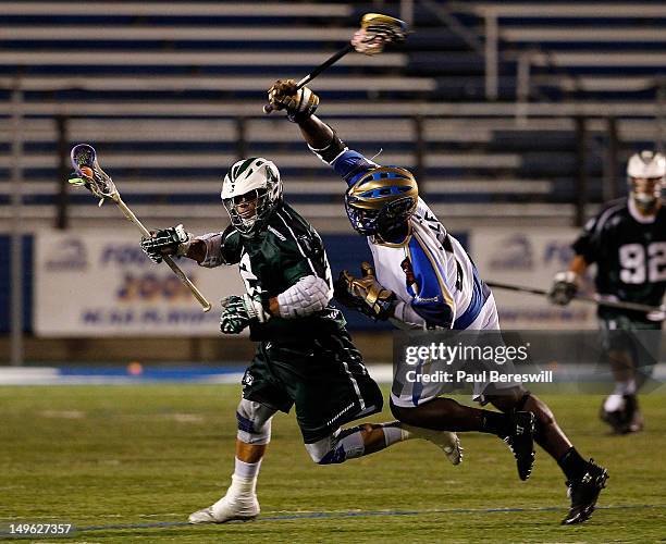 Jovan Miller of the Charlotte Hounds tries to stop Greg Gurenlian of the Long Island Lizards in the fourth quarter of a Lacrosse game at James M....