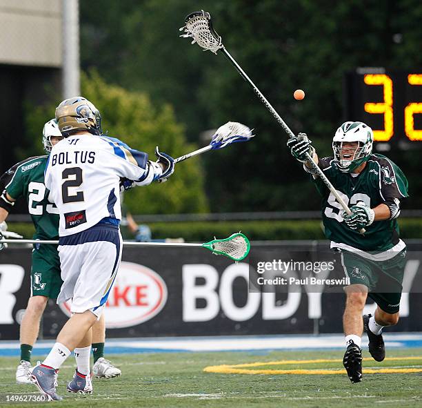 Michael Skudin of the Long Island Lizards tries to stop a shot by Jeremy Boltus of the Charlotte Hounds in the second quarter of a Lacrosse game at...