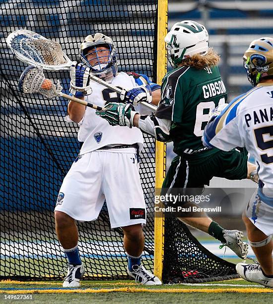 Matt Gibson of the Long Island Lizards scores a goal against goalie Adam Ghitelman of the Charlotte Hounds in the first quarter of a Lacrosse game at...