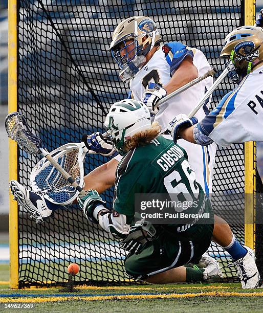 Matt Gibson of the Long Island Lizards scores a goal against goalie Adam Ghitelman of the Charlotte Hounds in the first quarter of a Lacrosse game at...