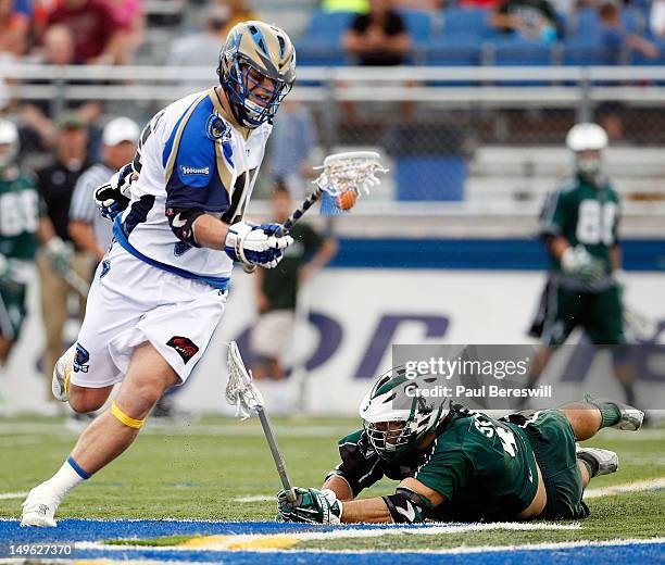 Kevin Kaminski of the Charlotte Hounds is checked by Max Seibold of the Long Island Lizards in the second quarter of a Lacrosse game at James M....