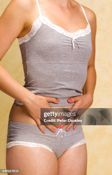 girl with stomach cramps or pains - food allergy stock pictures, royalty-free photos & images
