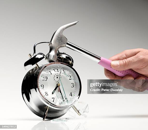 smashing an alarm clock with a hammer - breaking habits ストックフォトと画像