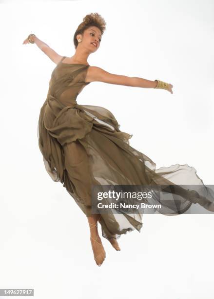 a mixed-race woman jumping for joy - danseuse photos et images de collection