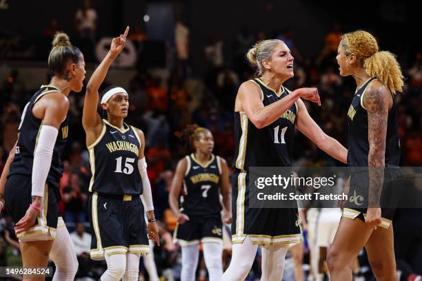 Elena Delle Donne and Shakira Austin of the Washington Mystics celebrate with teammates after a play against the Dallas Wings during the second half...