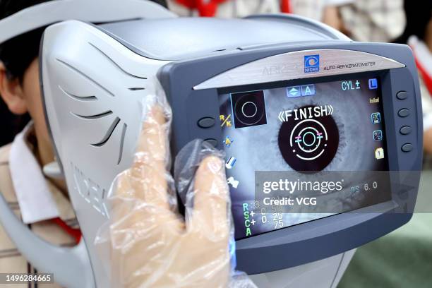 An ophthalmologist checks eyesight of a child at a primary school during the National Eye Care Day on June 6, 2023 in Zaozhuang, Shandong Province of...