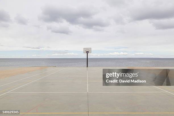 basketball court with straits of magellan beyond. - basketball hoop stock pictures, royalty-free photos & images