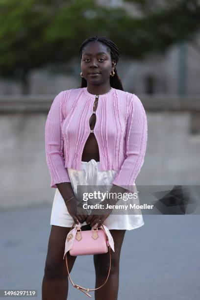 Lois Opoku wearing Chanel canvas beige ballerinas, Chanel pink logo summer cardigan, Louis Vuitton mini Speedy pink shiny bag and Zara silk beige...