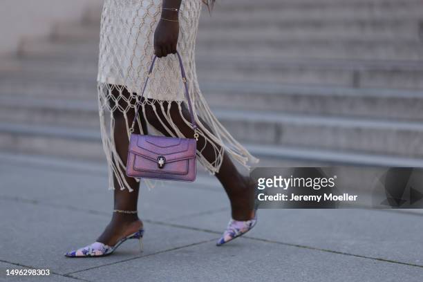 Lois Opoku wearing Bulgari lilac metallic shiny Serpenti leather bag, Emilio Pucci lilac kitten heels, H&M fringe crocket beige skirt, Altuzarra...
