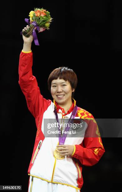 Xiaoxia Li of China stands on the podium after winning the Gold medal in the Women's Singles Table Tennis Gold Medal match against Ning Ding of China...