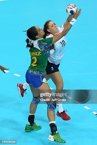 Fabiana Diniz of Brazil competes with Kelsi Fairbrother of Great Britain in the Women's Handball Preliminaries Group A match between Great Britain...