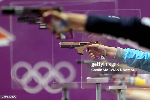 Shooters compete in the 25m pistol women precision and rapid final at the Royal Artillery Barracks in London on August 1, 2012 during the London 2012...