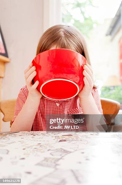 girl (6-7) drink milk from breakfast bowl - bowl of cereal imagens e fotografias de stock