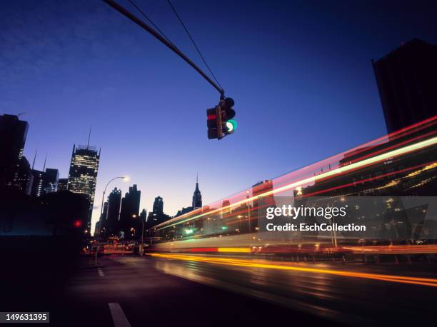 traffic entering midtown, new york at early dawn. - traffic light city stockfoto's en -beelden