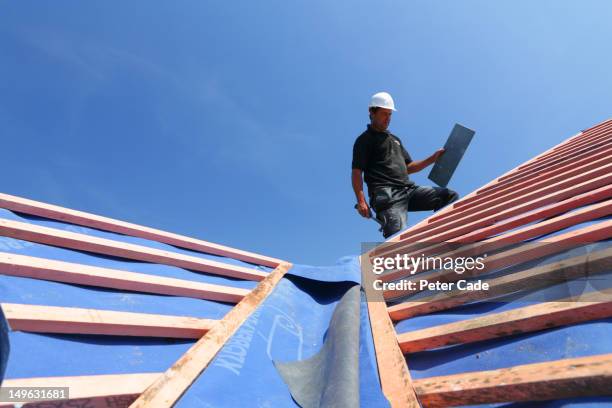 man tiling roof - roofer stock pictures, royalty-free photos & images