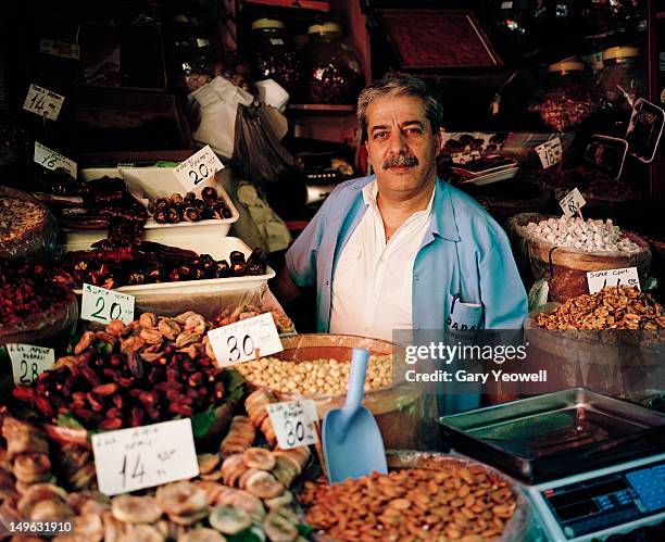 dried fruit and nut seller in the spice market - market trader fotografías e imágenes de stock