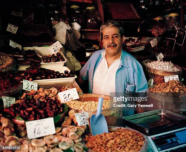 dried fruit and nut seller in the spice market - market vendor imagens e fotografias de stock