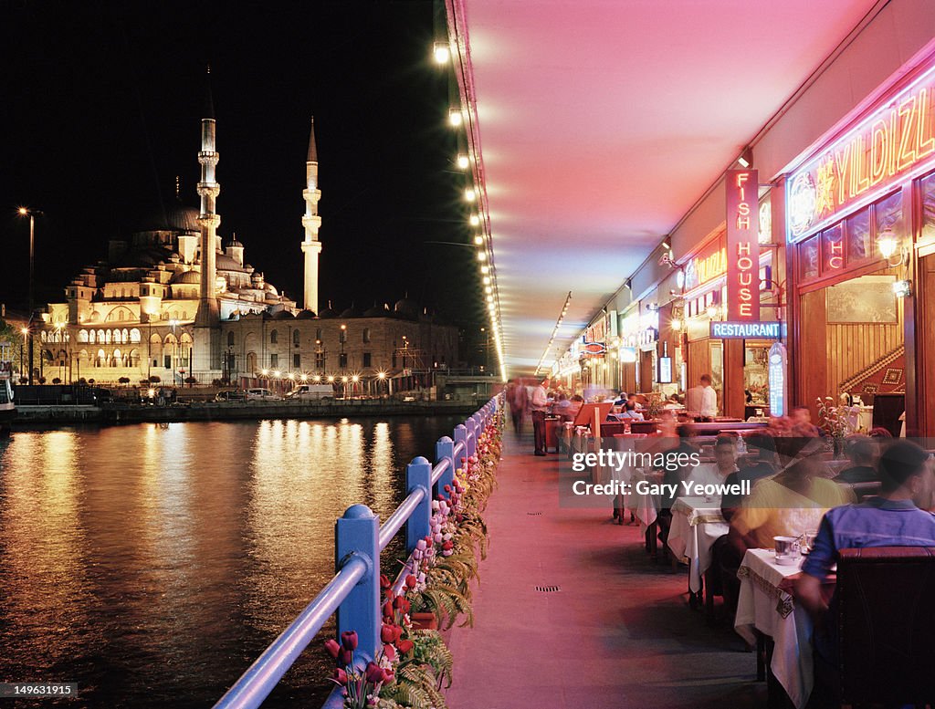 Tourists dining along Galata Bridge at night