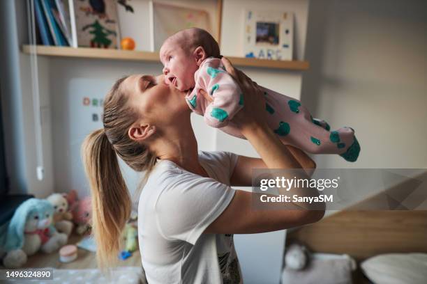 mother is taking care of newborn baby - carefree moment stock pictures, royalty-free photos & images