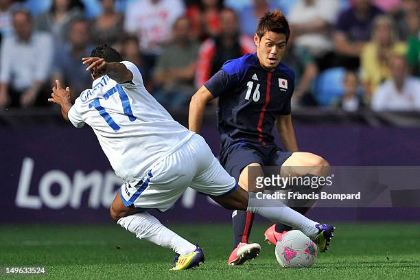 Hotaru Yamaguchi of Japan and Luis Garrido of Honduras battles for the ball during the Men's Football first round Group D Match between Japan and...