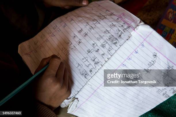 January 27, 2017: Joyti tutoring young children after school at her home on January 27, 2017 in Vasni Mafi, Rajasthan, India. Joyti was married at a...