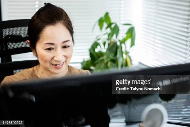 a female officer checking documents in her office. - chief investment officer stock pictures, royalty-free photos & images