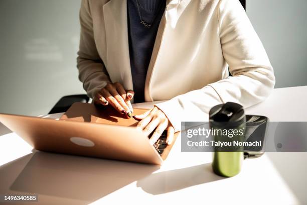 a woman working at her desk with a laptop. - personal perspective or pov stock-fotos und bilder