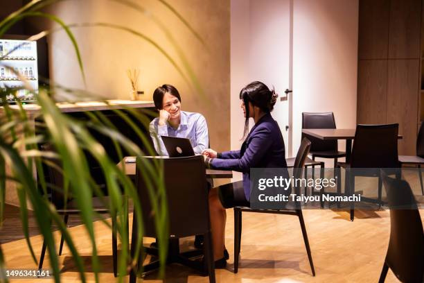 a man listens to a female consultant invited to his company. - ornamental plant stock pictures, royalty-free photos & images