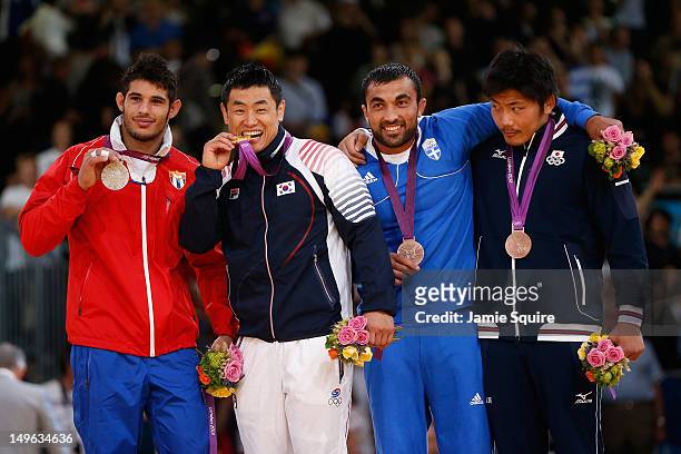 Silver medalist Asley Gonzalez Montero of Cuba, Gold medalist Dae-Nam Song of Korea, Bronze medalist A Ilias Iliadis of Greece, and Bronze medalist B...