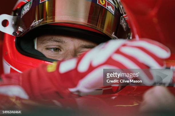 Rubens Barrichello from Brazil adjusts the wing mirror position from the cockpit of the Scuderia Ferrari Marlboro Ferrari F1-2001 Ferrari V10 during...