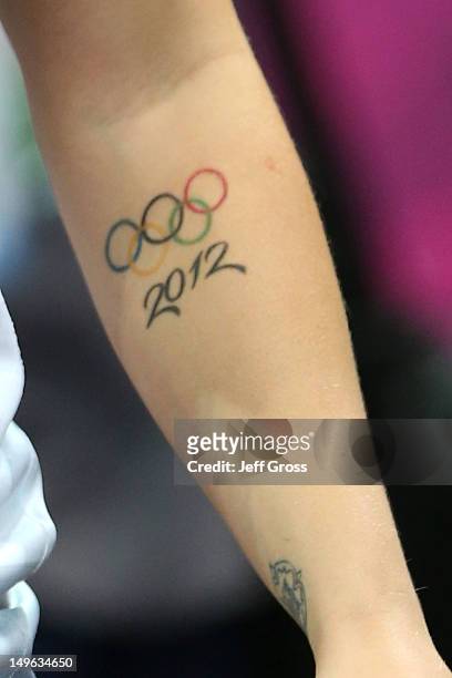 Detail photo of a 2012 Olympic tattoo on Kelsi Fairbrother of Great Britain during the Women's Handball Preliminaries Group A match between Great...