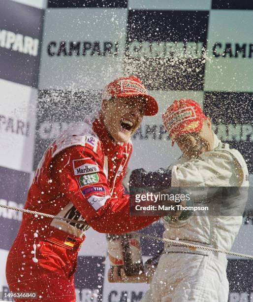 Michael Schumacher from Germany, driver of the Scuderia Ferrari Marlboro Ferrari F1-2000 Ferrari V10 sprays Mumm Cordon Rouge Champagne with his...