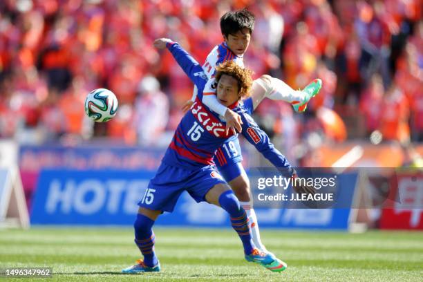 Akito Kawamoto of Ventforet Kofu and Kim Jin-su of Albirex Niigata compete for the ball during the J.League J1 match between Ventforet Kofu and...